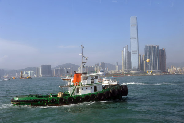 Tugboat in front of the growing skyline of Kowloon