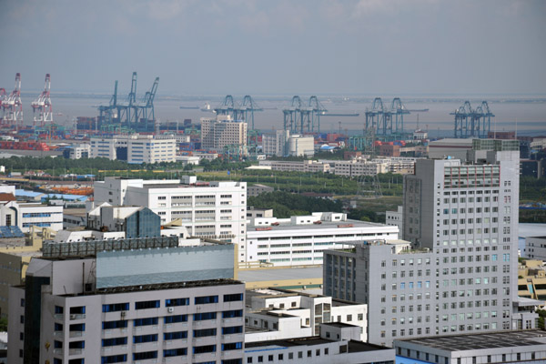 In the distance, cranes of the port of Zhoujiazhai at the mouth of the Yangtze River