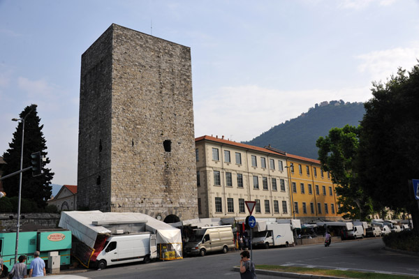 Market day along Via Carlo Cattaneo with Porta Torre