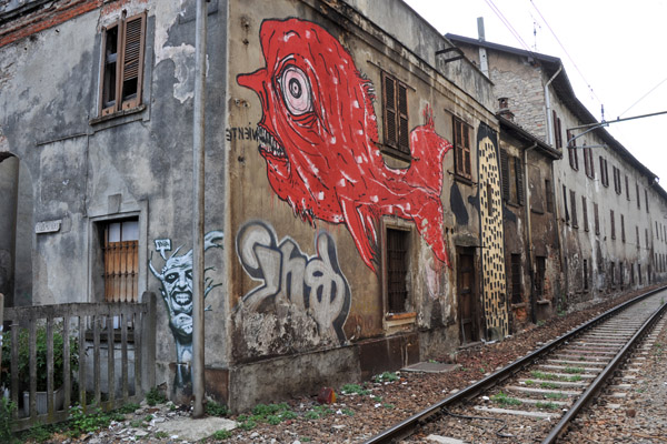 Graffiti along the railroad tracks across from the old city, Como