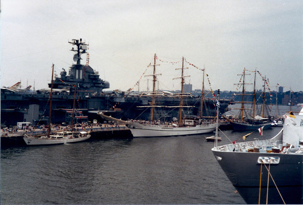The Intrepid with tall ships during the celebrations for the reopening of the Statue of Liberty