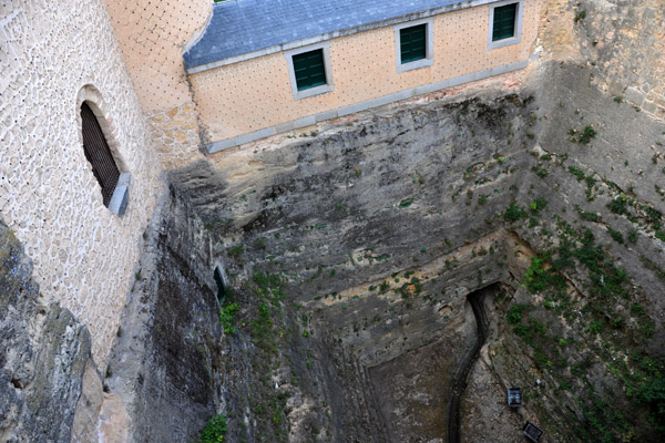 The deep chasm of the dry moat from the bridge leading into the Alczar