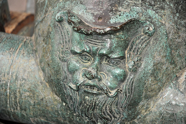Detail of a face on a piece of artillery