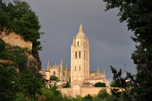 The sun breaks through to light up the tower of Segovia Cathedral