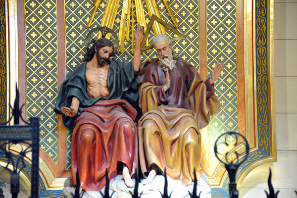 Jesus with God the Father, identified by the triangular halo representing the Holy Trinity