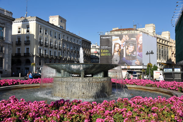 Fountain surrounded by flowers, Puerta del Sol, Madrid