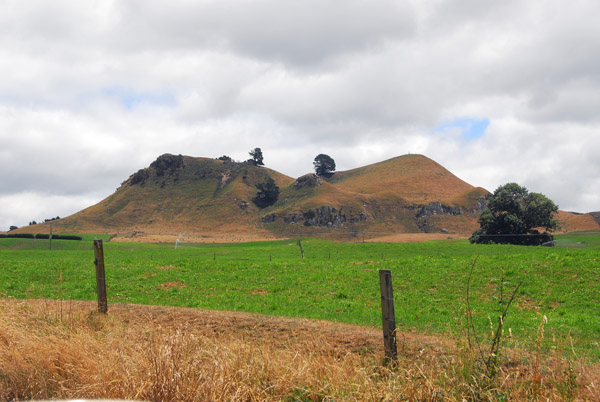 Cinder cone in a green field on the road to Orakei Korako