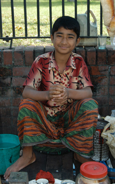 Young sidewalk salesman, Dhaka