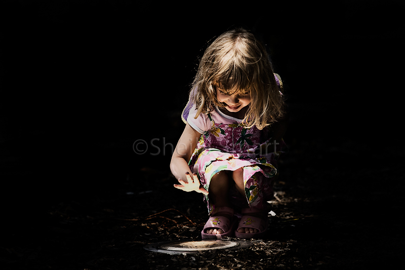 Little girl under and over spot light