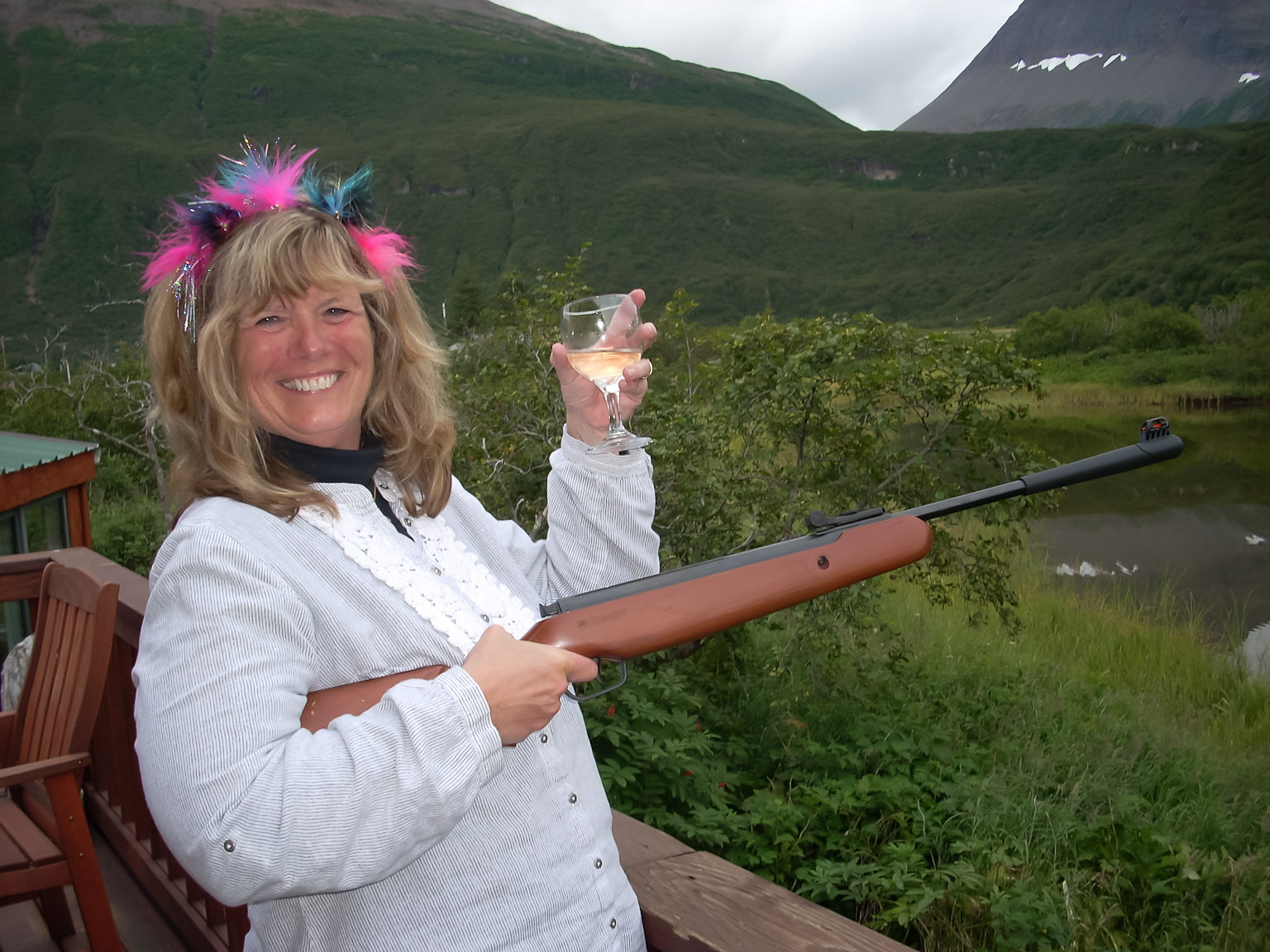 A tiara, champagne, and a gun .. ready to party
