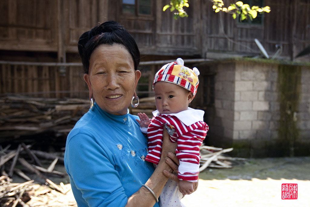 Lady and grandchild, Da Zai village, Long Ji, China.
