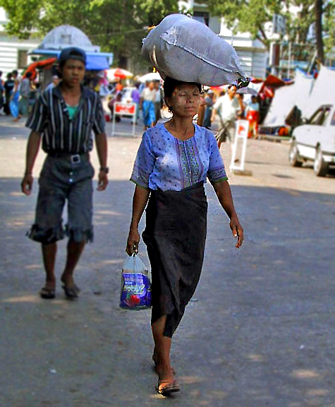 Woman with sack on her head and paste on her face