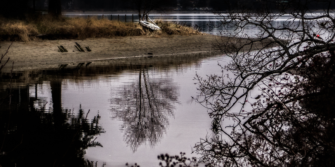 Tree reflection and boat, Beaver Creek, Vancouver Island