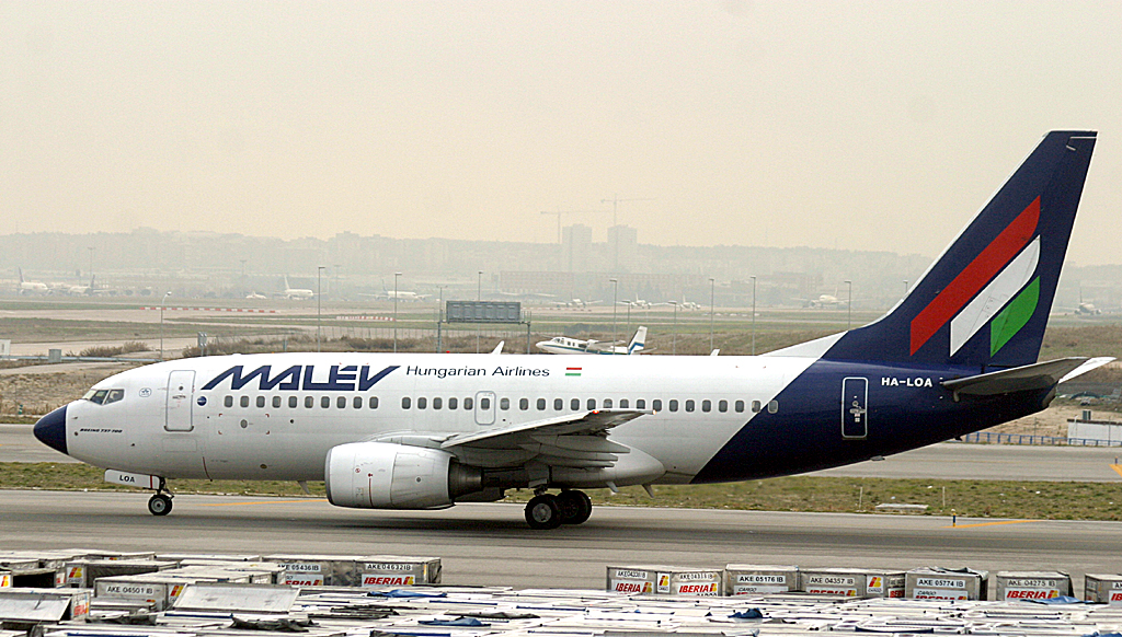 Malev 737-300 taxi past a sea of cargo containers