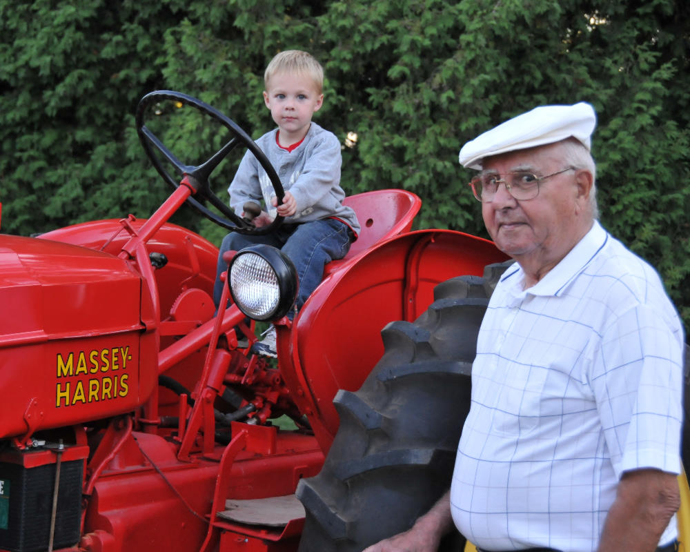 Camden and Great Grandpa with the Massy Harris 30 that he bought 50 years ago