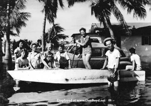 1947 - Jerry Oliver (front of boat, arm on edge) and Allapattah neighbors after the Flood of 1947 caused by a hurricane