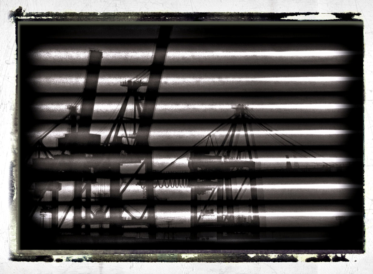 harbour cranes reflected on window shades