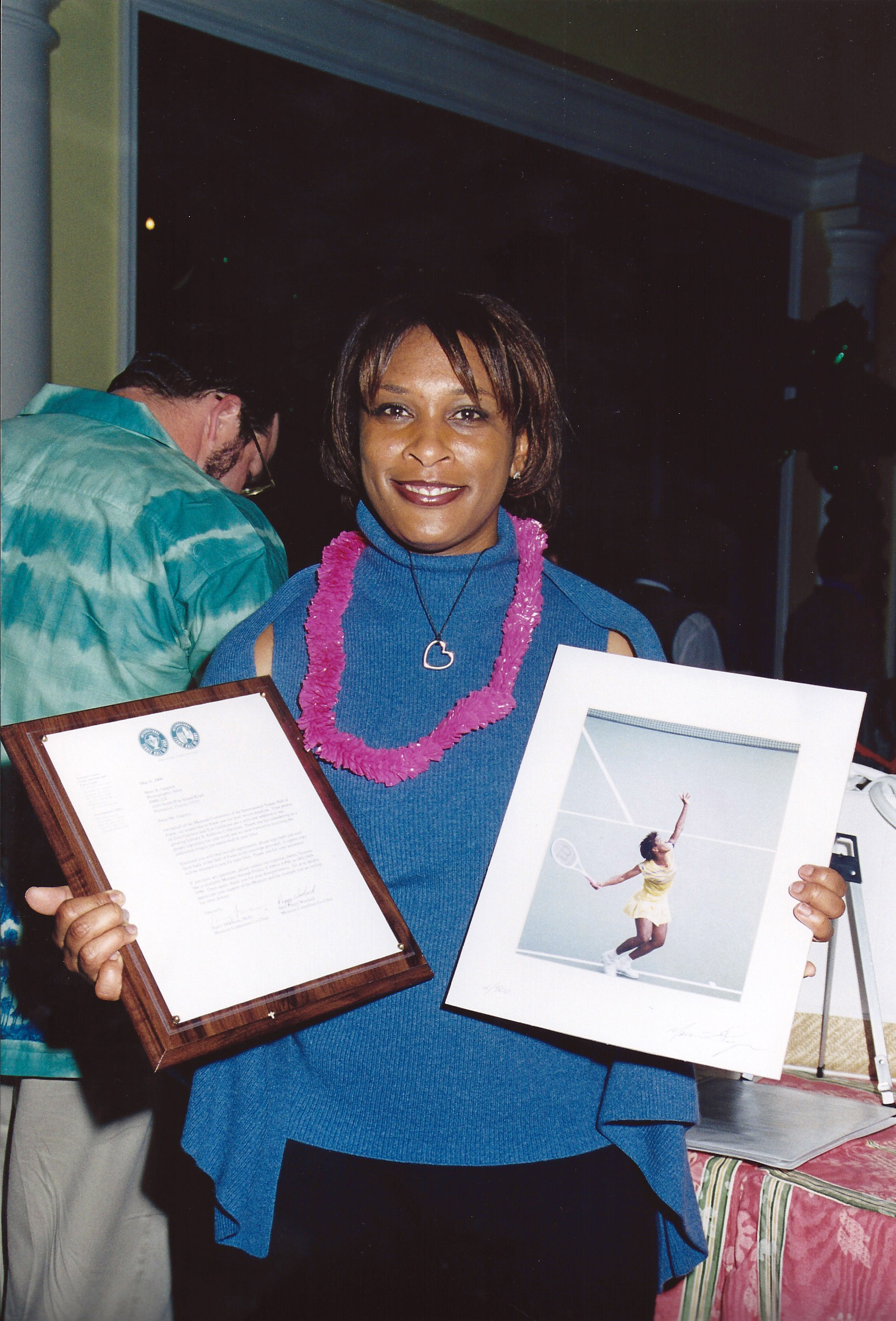 Zina Garrison holding Gagnons work with Tennis Hall of Fame letter of collection