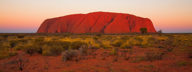 Uluru lit up by the very last bit of sunshine