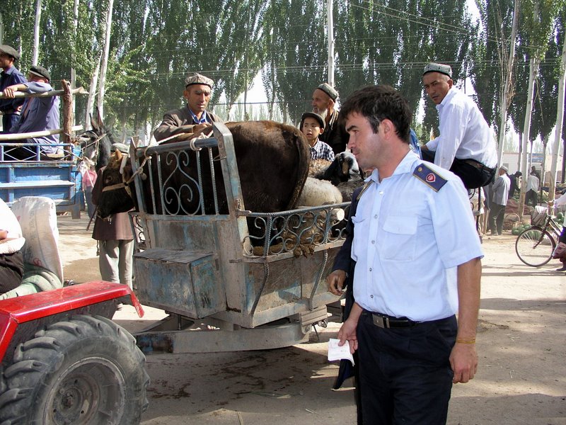 Official checks whats coming & going at the Kashgar Sunday Market