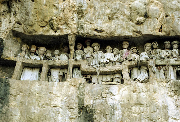 Tau Tau or effigies of the dead adorn graves in a cliff face