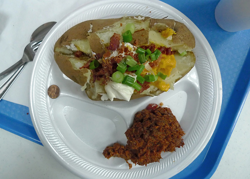 THE FEEDING LADIES GAVE ME A TEXAS POTATO!  - (THE PENNY ON THE PLATE HELPS SHOW ACTUAL SIZE)