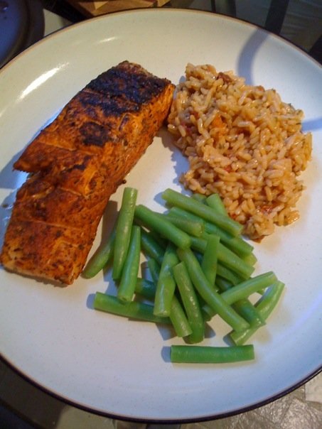 Salmon filets with Northwest spice rub, sundried-tomato basil rice, and steamed green beans