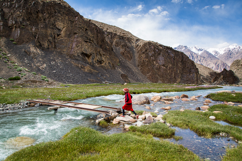 Girl leaping onto bridge - Tajikistan