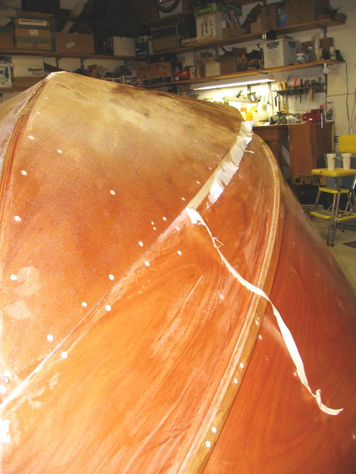 Razor blade run along tape edge while resin is still green, then excess is pulled up and away.