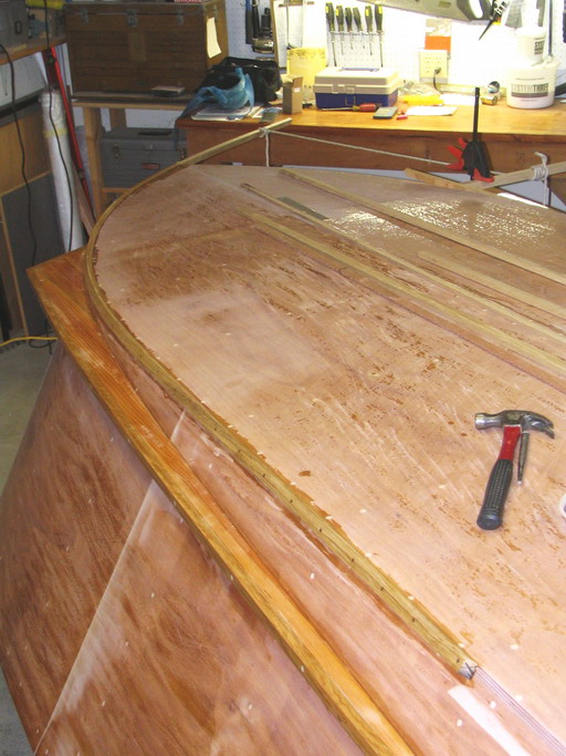 First chine guard segment -- aft portion nailed and epoxied on, looking aft.