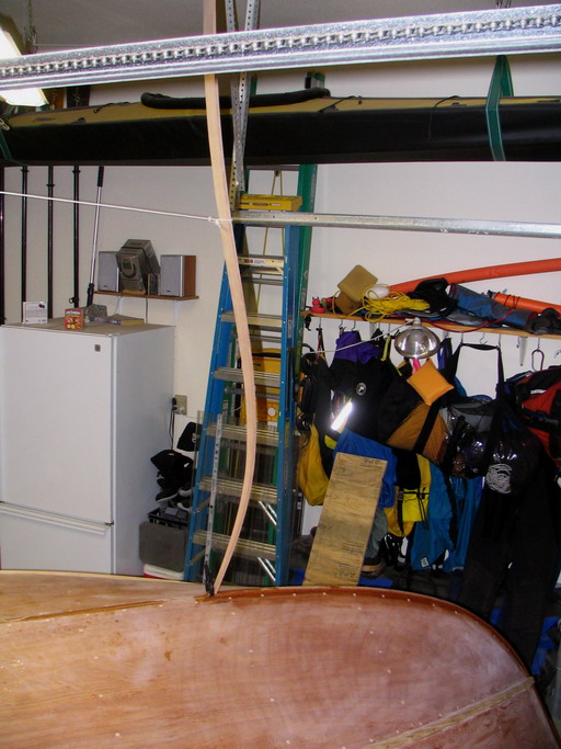 Wood brace off ceiling holds the aft end of keel strip in place while the epoxy cures.