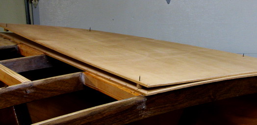 Bow decking requires care as the panel is aligned onto glue-covered frames, etc.  Drywall screws index the sheet, making for a o