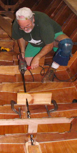 Power boring the first attempt at the shaft hole, with jig board to hold the angle.