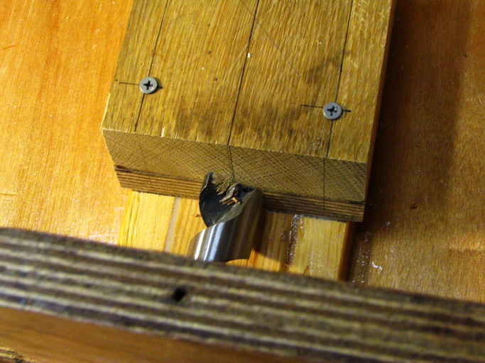 Shoddy hole filled with epoxy/wood flour; oak/plywood guide block helped the bit run true.