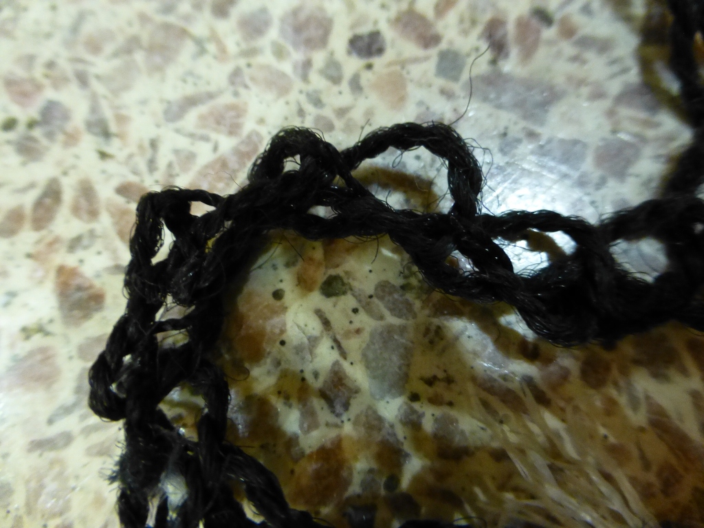 Frayed corner of carpet and floor