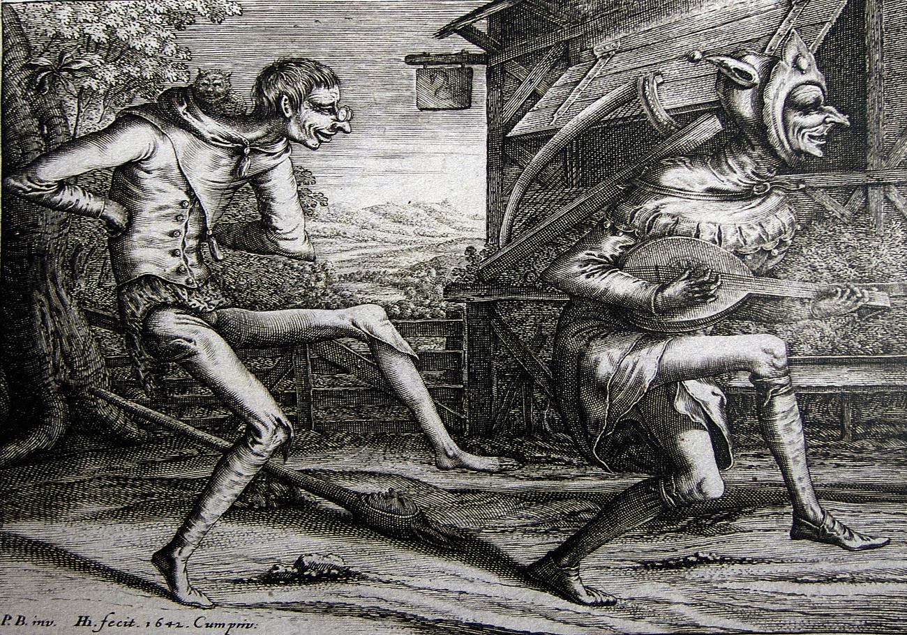 Two carnival fools dancing in front of an inn