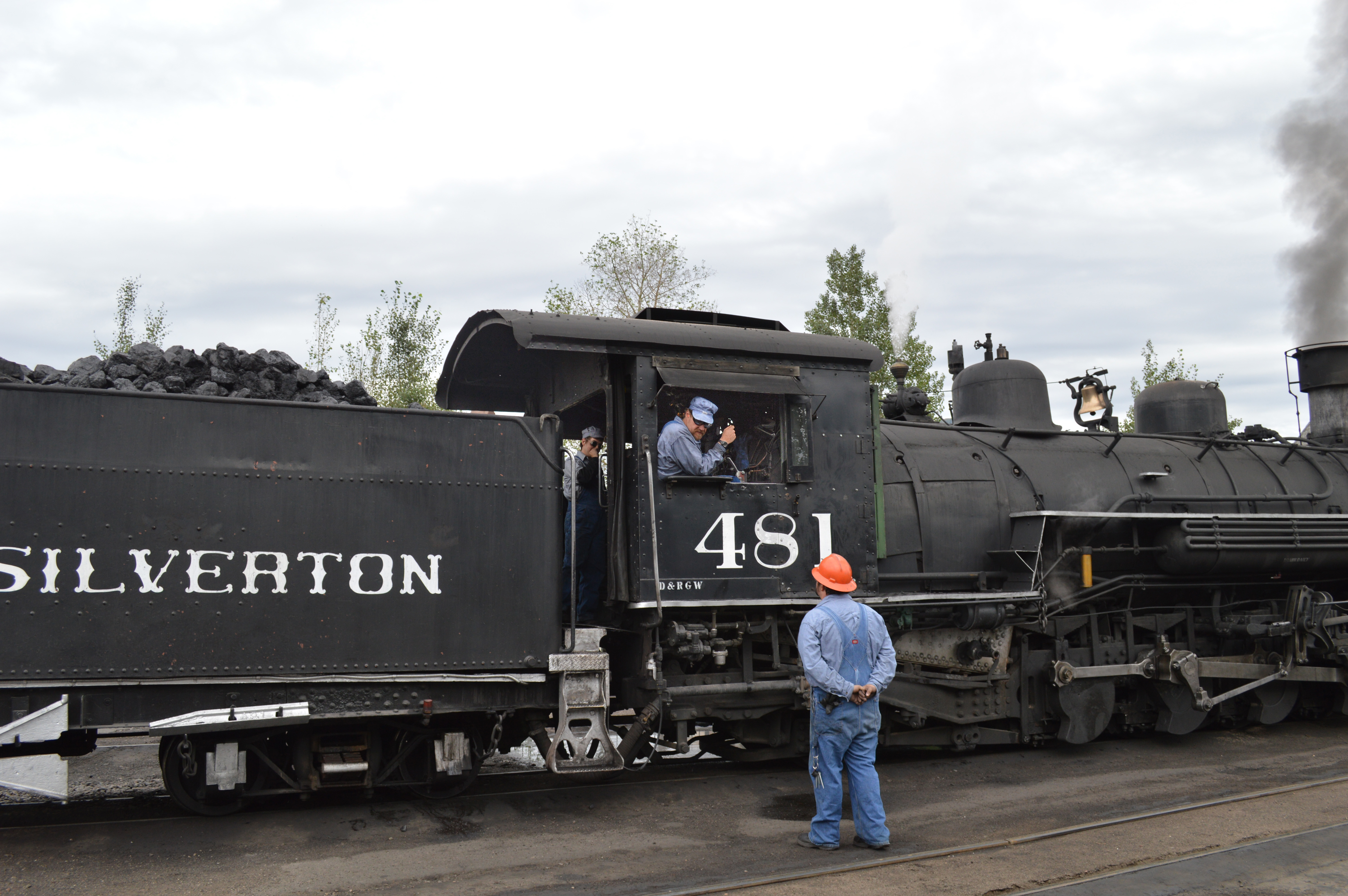 2 The crew of 481 talk with the car knocker as the first train of the day gets ready to leave Durango