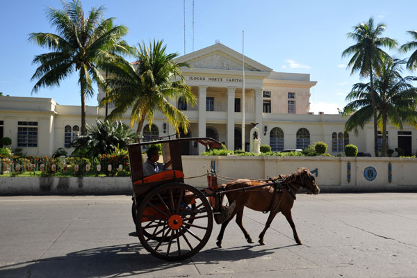 Kalesa passing in front of the Ilocos Norte Capitol, Laoag