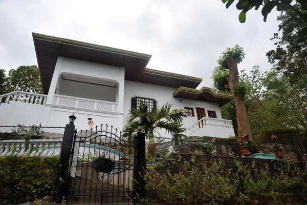 The stairs leading up to Agila Hill are to the right of this villa