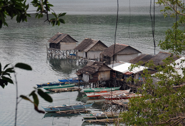 Fishermen's huts with their outrigger banca canoes, Culion