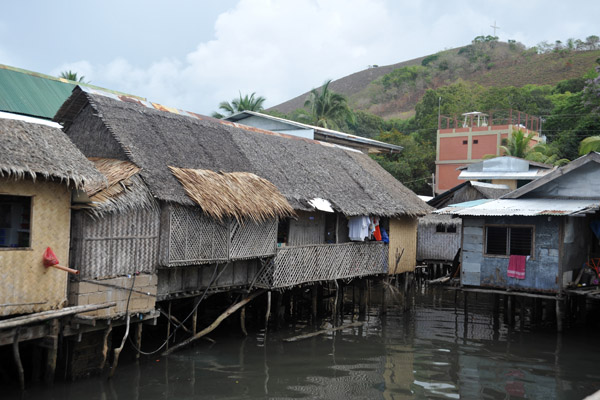 Traditional nipa huts along the Coron waterfront next to Amphibiko