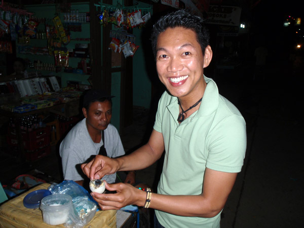 Dennis salting a balut