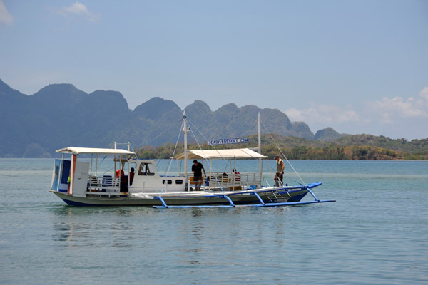 SeaDive's large boat with Coron Island in the distance