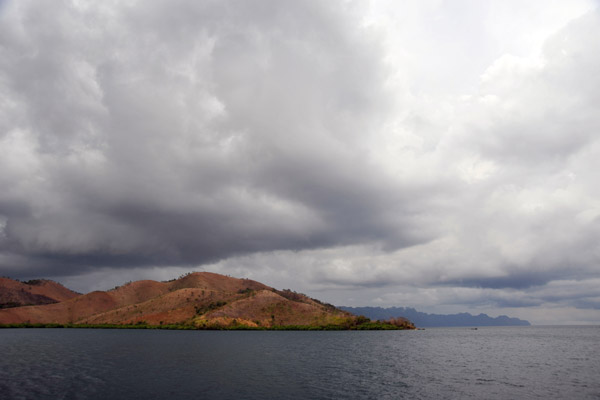 Storm clouds over southern Busuanga with the south end of Coron Island in the distance
