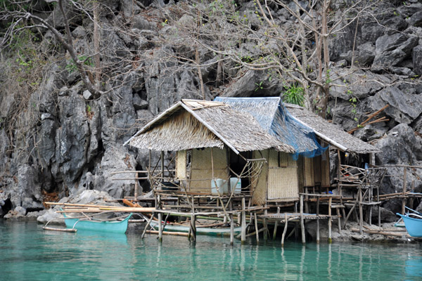 There are several stilt huts around the cove at Kayangan