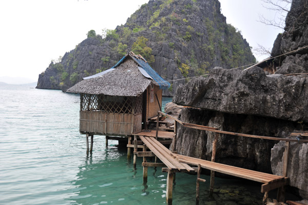 Stilt huts built around the Kayangan cove, Coron Island