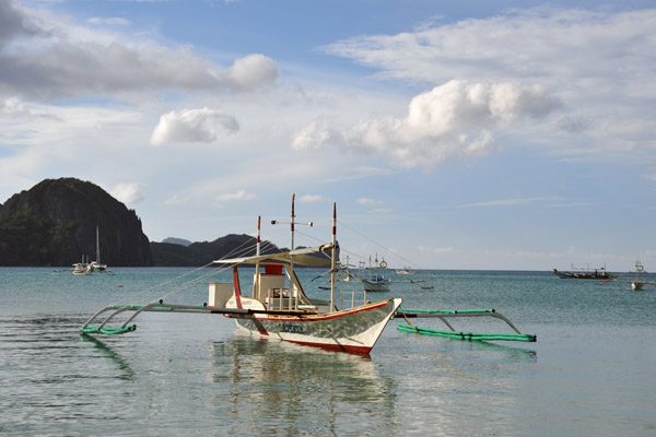 Banca floating on the smooth water off El Nido
