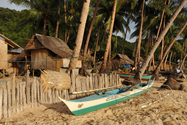 Outrigger canoe on the beach by the village