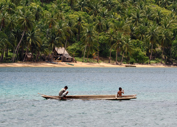 Boys fishing from a canoe near Snake Island