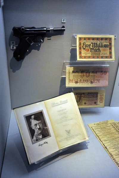 A copy of Mein Kampf with a Lugar pistol and 1920s German marks